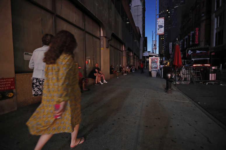 People walk in midtown Manhattan during a widespread power outage, Saturday, July 13, 2019, in New York. NYC blackout