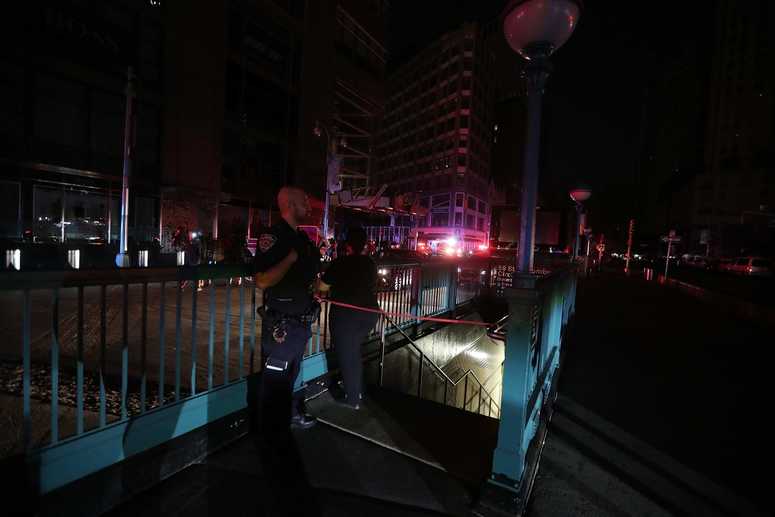 A member of the NYPD stands by a closed subway station at Columbus Circle in Manhattan was closed as subways were shut down after a power outage left large parts of the West Side of Manhattan without power July 13, 2019. NYC power outage