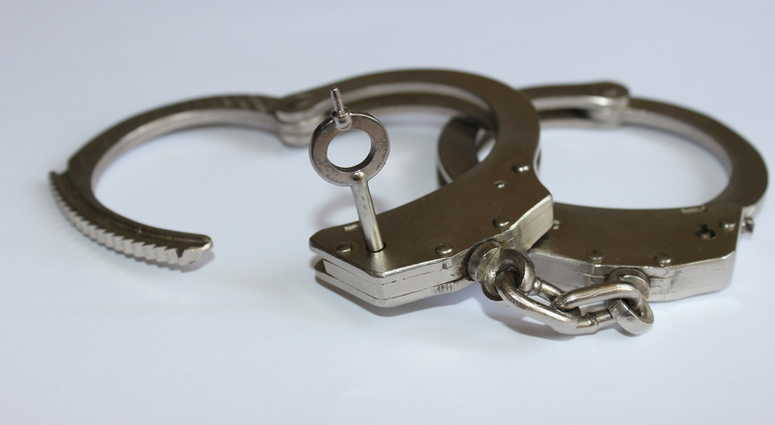 A pair of handcuffs. A pair of handcuffs.
