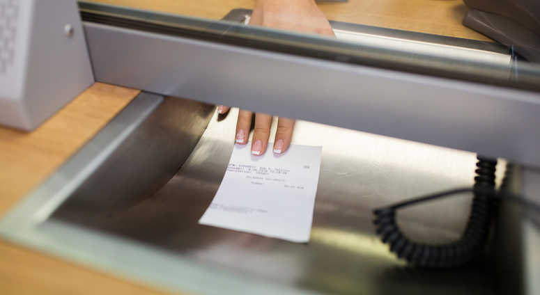 Clerk giving receipt at bank. Clerk giving receipt at bank.