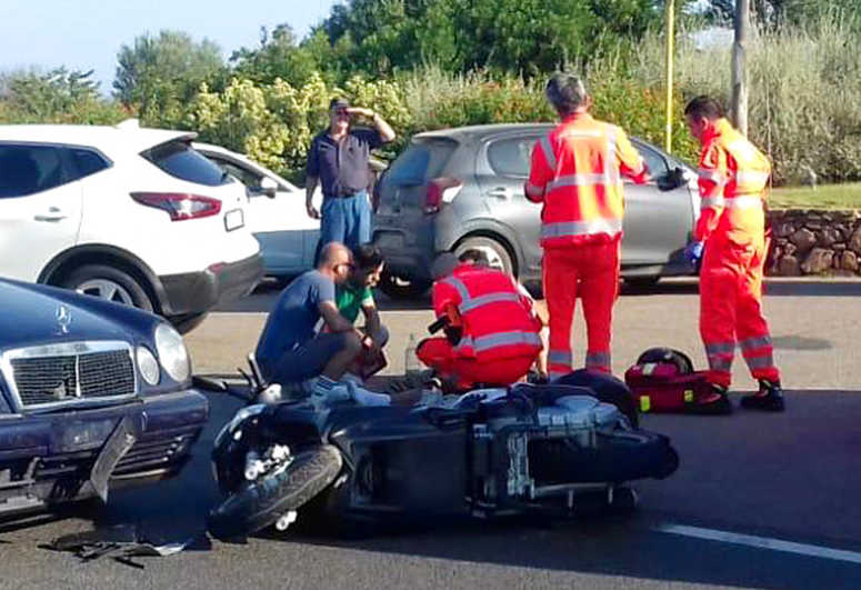 Ambulance personnel tend to a man lying on the ground, later identified as actor George Clooney, after being involved in a scooter accident in the near Olbia, on the Sardinia island, Italy, Tuesday, July 10, 2018.