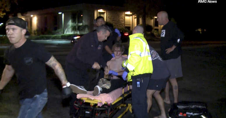 In this image taken from video a victim is treated near the scene of a shooting, Wednesday evening, Nov. 7, 2018, in Thousand Oaks, Calif. In this image taken from video a victim is treated near the scene of a shooting, Wednesday evening, Nov. 7, 2018, in Thousand Oaks, Calif.