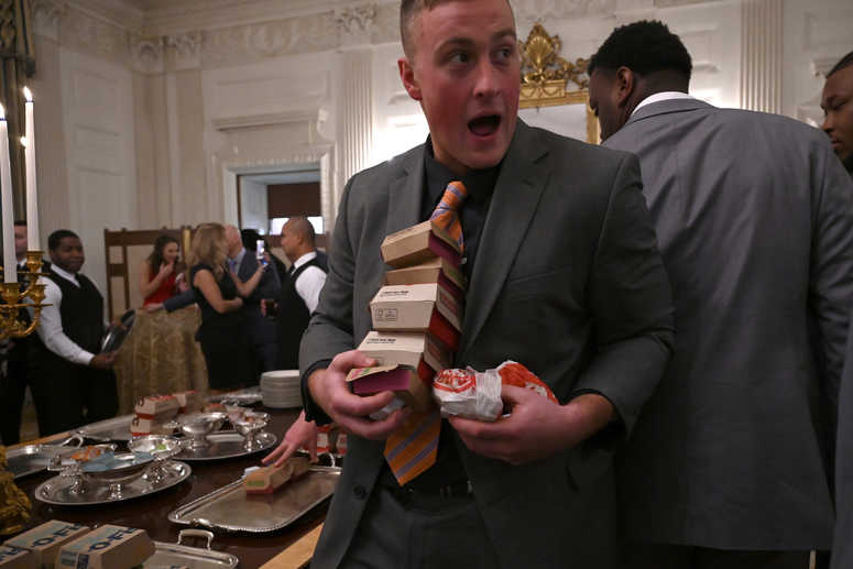 Guests attending a reception for the Clemson Tigers grab fast food sandwiches in the State Dining Room of the White House in Washington, Monday, Jan. 14, 2019. Trump McDonalds