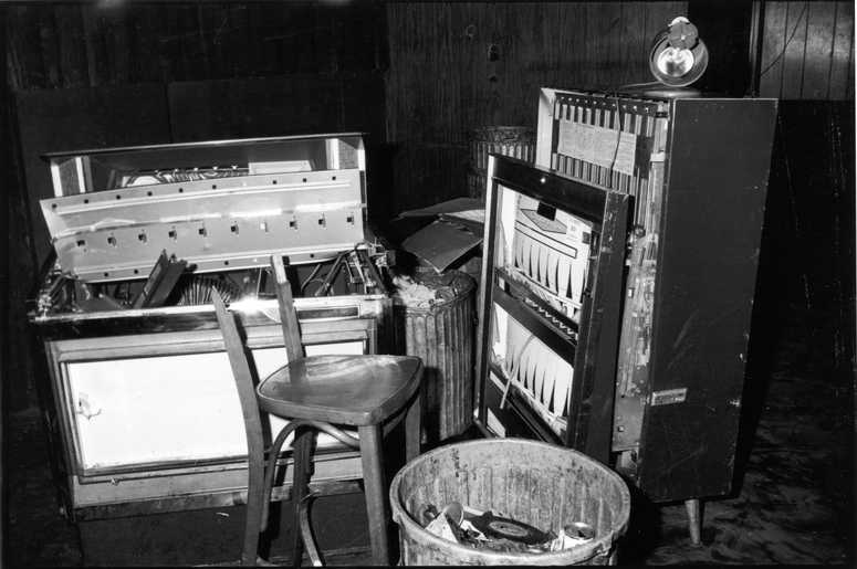 View of a damaged jukebox and cigarette machine, along with a broken chair, inside the Stonewall Inn (53 Christopher Street) after riots over the weekend of June 27, 1969. (Photo by Fred W. McDarrah/Getty Images)