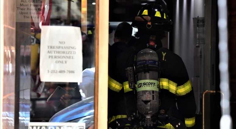 A fireman in a narrow doorway of the Park Savoy. Park Savoy