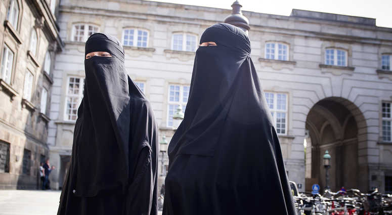 Women in niqab walk, in front of the Danish Parliament at Christiansborg Castle, in Copenhagen, Denmark, Thursday May 31. 2018. Women in niqab walk, in front of the Danish Parliament at Christiansborg Castle, in Copenhagen, Denmark, Thursday May 31. 2018.