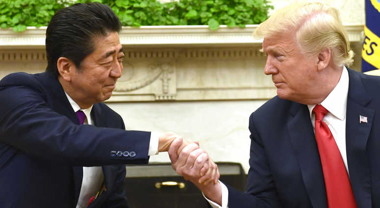 President Donald Trump shakes hands with Japanese Prime Minister Shinzo Abe