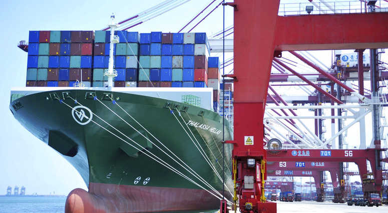 A ship hauls containers at a container port in Qingdao in eastern China's Shandong province Friday, July 6, 2018.