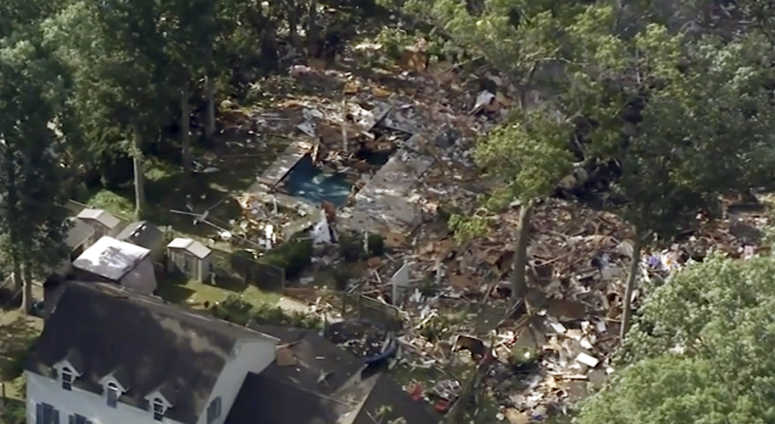 Debris covering the ground after a house exploded. NJ House explosion AP