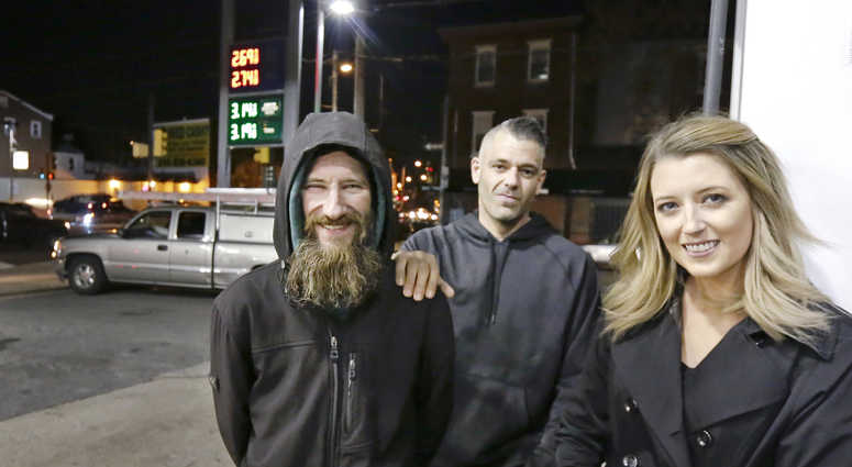 In this Nov. 17, 2017, file photo, Johnny Bobbitt Jr., left, Kate McClure, right, and McClure's boyfriend Mark D'Amico pose at a Citgo station in Philadelphia. In this Nov. 17, 2017, file photo, Johnny Bobbitt Jr., left, Kate McClure, right, and McClure's boyfriend Mark D'Amico pose at a Citgo station in Philadelphia.