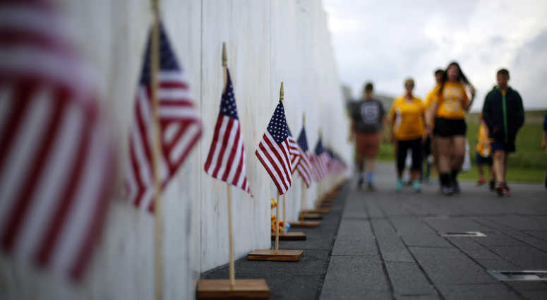 Visitors to the Flight 93 National Memorial pause at the Wall of Names containing the names Flight 93 National Memorial