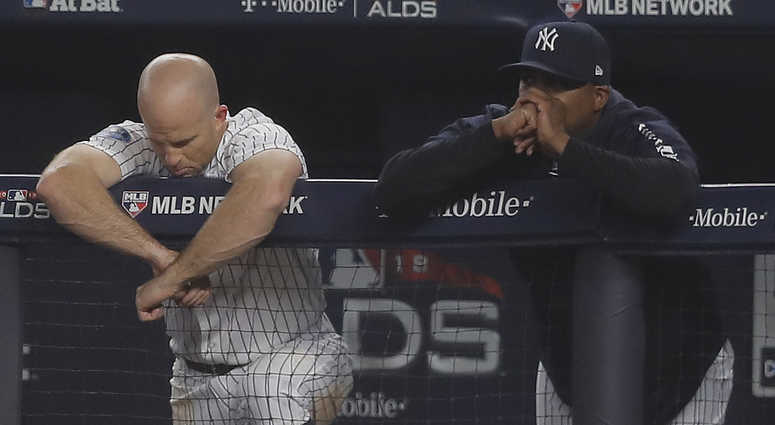 New York Yankees' Brett Gardner, left, and hitting coach Marcus Thames watch play against the Boston Red Sox from the dugout during the eighth inning of Game 3 of baseball's American League Division Series, Monday, Oct. 8, 2018