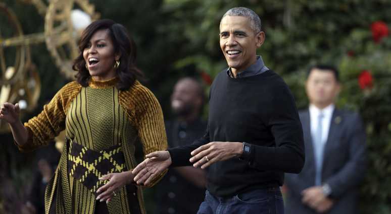 FILE - In this Oct. 31, 2016 file photo, President Barack Obama and the first lady Michelle Obama dance with kids to the beat of "Thriller" during a Halloween celebration at the South Portico of the White House in Washington. Barack and Michelle Obama
