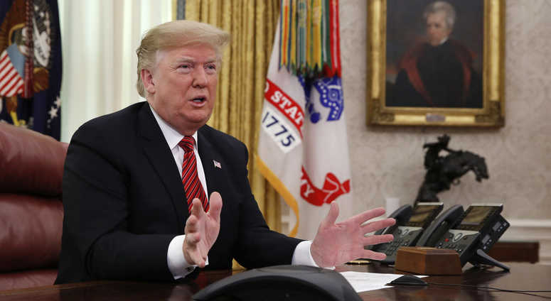 President Donald Trump greets members of the five branches of the military by video conference on Christmas Day, Tuesday, Dec. 25, 2018, in the Oval Office of the White House Trump Oval Office