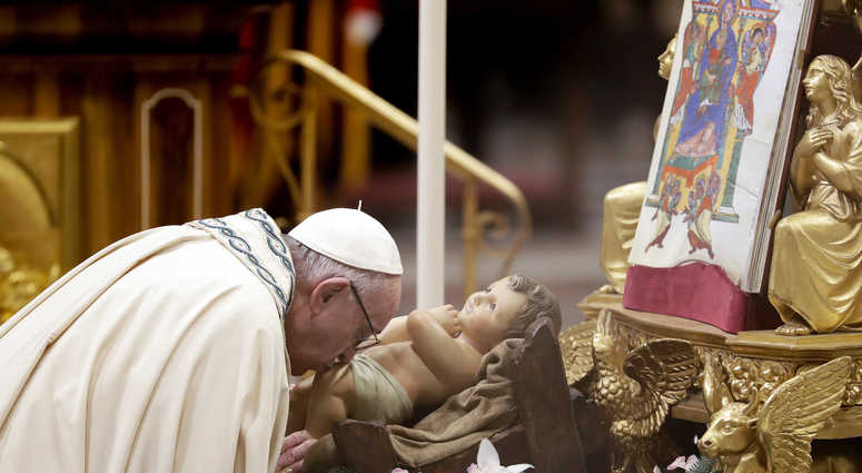 Pope Francis kisses a statue of Baby Jesus as he celebrates a new year's eve vespers Mass in St. Peter's Basilica at the Vatican, Monday, Dec. 31, 2018. New Year Vatican