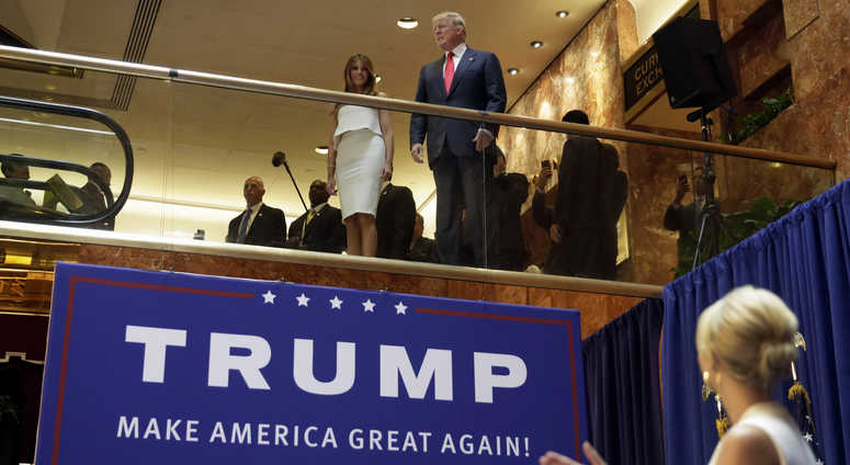 In this Sunday, June 16, 2015, file photo, Donald Trump, accompanied by his wife Melania Trump, is applauded by his daughter Ivanka Trump, right as he's introduced before his announcement that he will run for president in the lobby of Trump Tower. Trump Tower