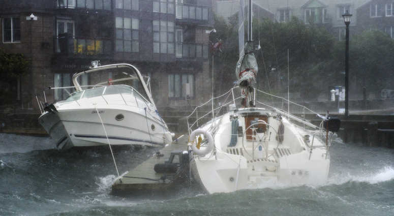 Waves crash into boats long the waterfront in Halifax, Nova Scotia as hurricane Dorian approaches on Saturday, Sept. 7, 2019. Hurricane Dorian