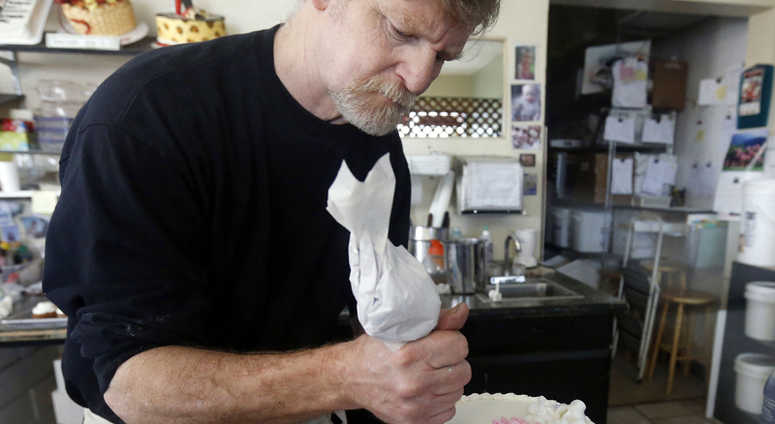 FILE - In this March 10, 2014, file photo, Masterpiece Cakeshop owner Jack Phillips decorates a cake inside his store in Lakewood, Colo. FILE - In this March 10, 2014, file photo, Masterpiece Cakeshop owner Jack Phillips decorates a cake inside his store in Lakewood, Colo.