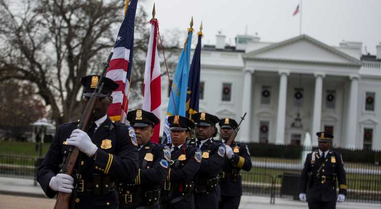 Honor Guard members depart after a hearse carrying the remains of former U.S. President George H.W. Bush passed the White House en route to the National Cathedral before a state funeral on December 5, 2018 in Washington, DC. George H.W. Bush