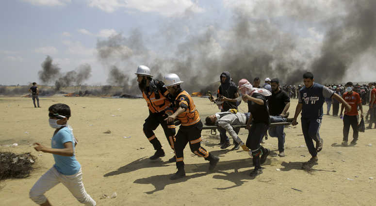 Palestinian medics and protesters evacuate a wounded youth during a protest at the Gaza Strip's border with Israel Palestinian medics and protesters evacuate a wounded youth during a protest at the Gaza Strip's border with Israel