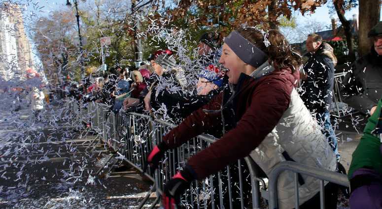 A parade watcher throws confetti during the 92nd annual Macy's Thanksgiving Day Parade on November 22, 2018 in New York City. Thanksgiving Day Parade 2018