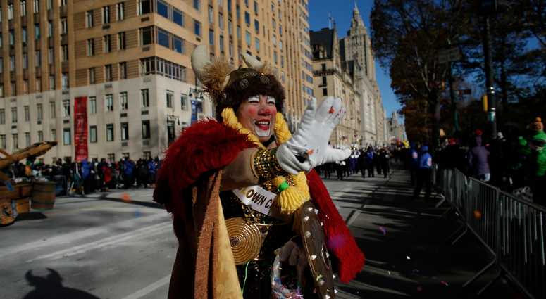 A parade participant dressed in costume waves to the crowd along the route during the 92nd annual Macy's Thanksgiving Day Parade on November 22, 2018 in New York City. Thanksgiving Day Parade 2018