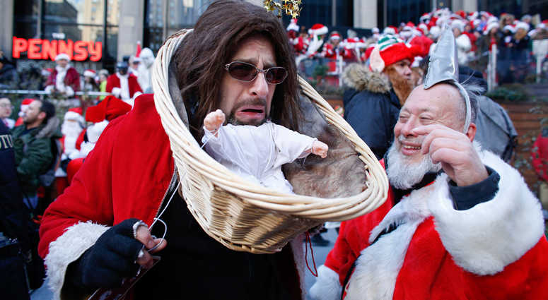 A man dressed up as Baby Jesus takes part during the annual New York SantaCon on December 8, 2018 in New York City. SantaCon is in it's 20th year in New York City. SantaCon 2018