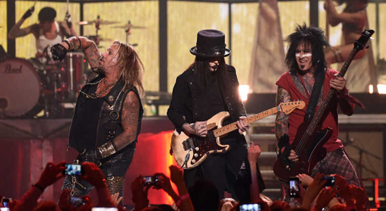 Singer Vince Neil, guitarist Mick Mars and bassist Nikki Sixx of Motley Crue perform during the 2014 iHeartRadio Music Festival at the MGM Grand Garden Arena on September 19, 2014 in Las Vegas, Nevada. Motley Crue