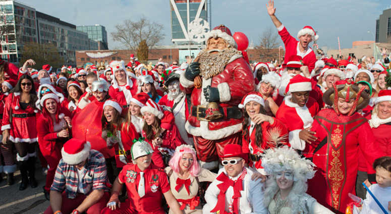 A crowd of people dressed as Santa gather for a group photo during the annual SantaCon pub crawl A crowd of people dressed as Santa gather for a group photo during the annual SantaCon pub crawl