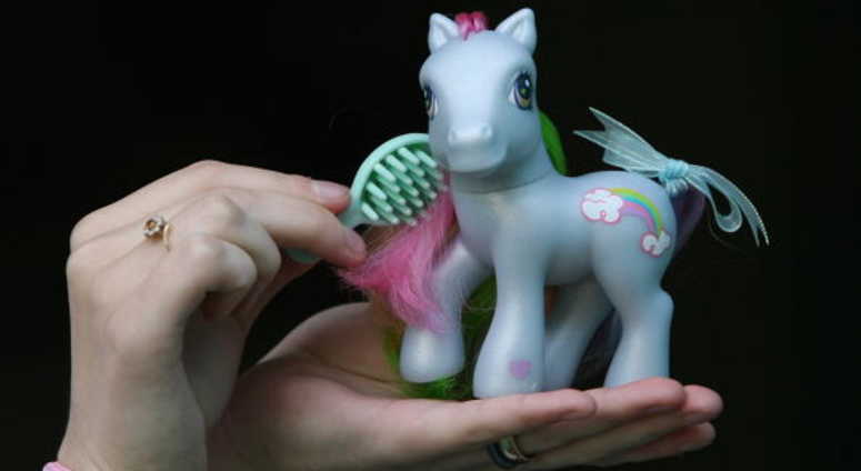 A collector prepares her My Little Pony for display at the My Little Pony Convention A collector prepares her My Little Pony for display at the My Little Pony Convention