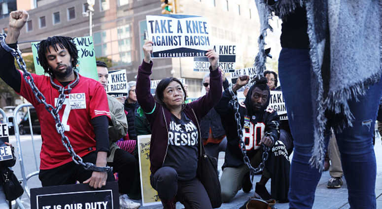 A coalition of advocacy groups 'take a knee' outside of a hotel where the quarterly NFL league meetings are being held A coalition of advocacy groups 'take a knee' outside of a hotel where the quarterly NFL league meetings are being held