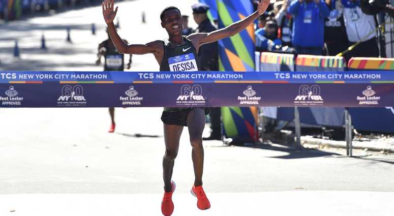 Lelisa Desisa crosses the finish line to win the professional men's division race of the 2018 TCS New York City Marathon. NYC Marathon