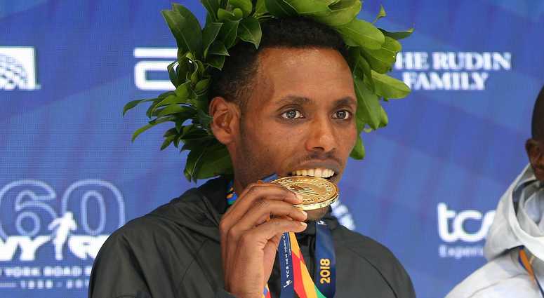 Lelisa Desisa of Ethiopia poses during the medal ceremony after winning the New York City Marathon in New York, NY. NYC Marathon
