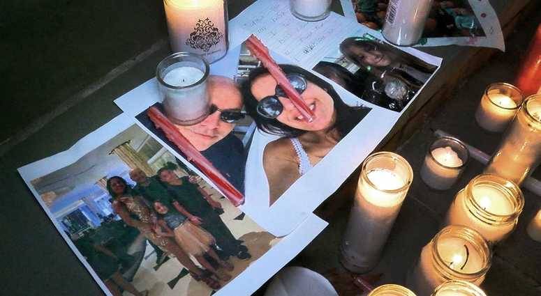 Photos of Keith Caneiro, his wife Jennifer, and children Jesse and Sophia are shown under candles during a vigil held outside the Colts Neck Town Hall Wednesday night, November 21, 2018. Colts Neck