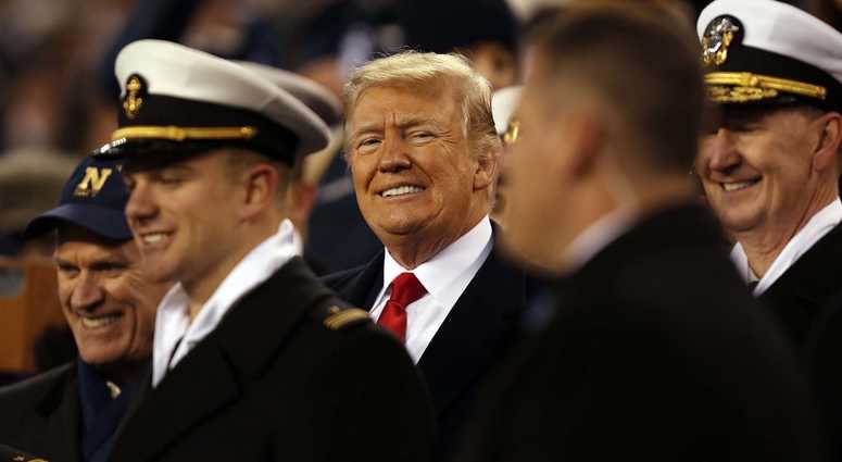 President Donald Trump stands with Naval Academy Midshipmen during halftime of the 119th Army-Navy game at Lincoln Financial Field. President Trump