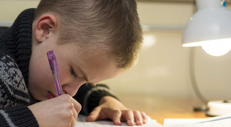 A student doing homework. A student doing homework.