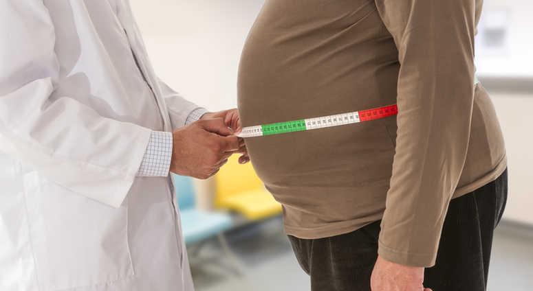 Doctor measuring an obese man. Doctor measuring an obese man.