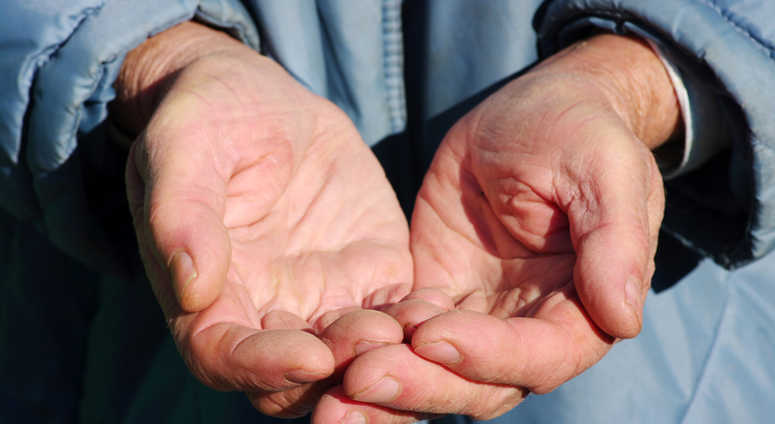Hands of a beggar with coins Hands of a beggar with coins