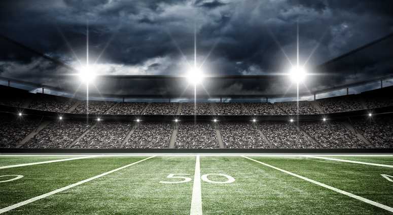 A football field under stadium lights