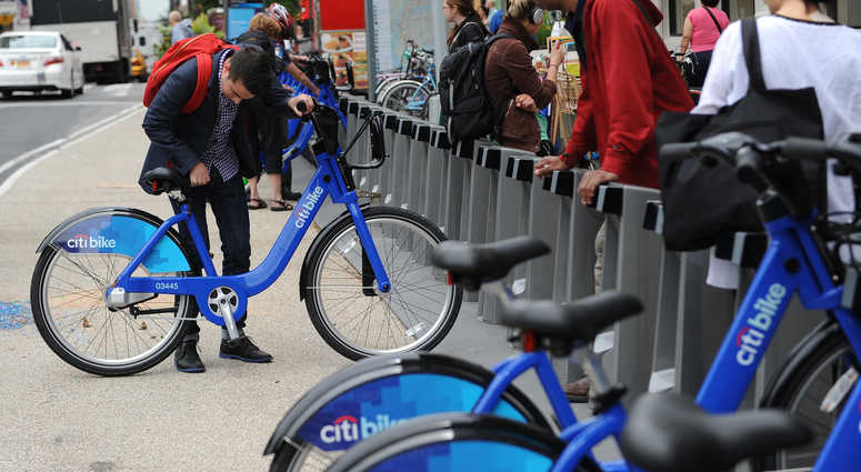 A man gets on a Citi Bike near Union Square. Citi Bike