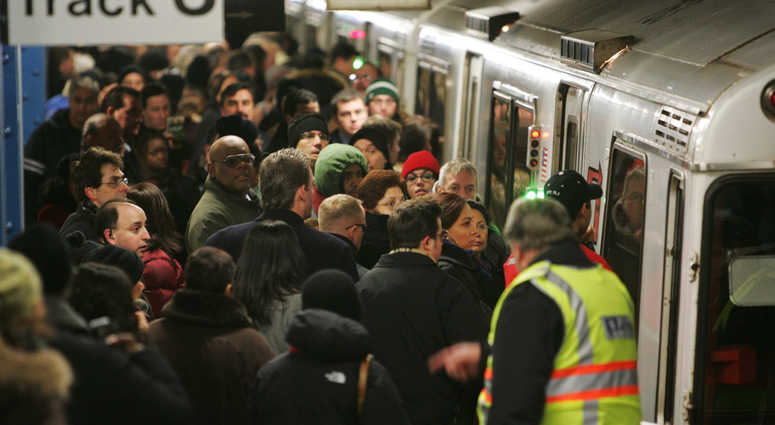 Commuters converge on the Port Authority Trans-Hudson (PATH) station at 32nd St. PATH train