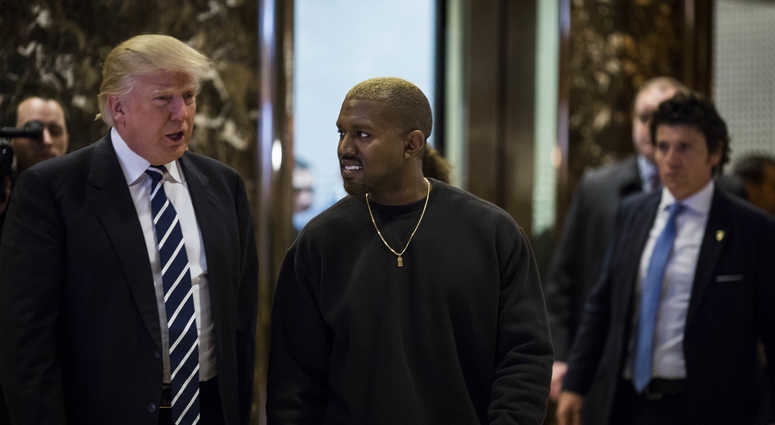 U.S. President-elect Donald J. Trump and Musician Kanye West pose for photographers in the lobby of Trump Tower in Manhattan, New York, U.S., on Tuesday, December 13, 2016. U.S. President-elect Donald J. Trump and Musician Kanye West pose for photographers in the lobby of Trump Tower in Manhattan, New York, U.S., on Tuesday, December 13, 2016.