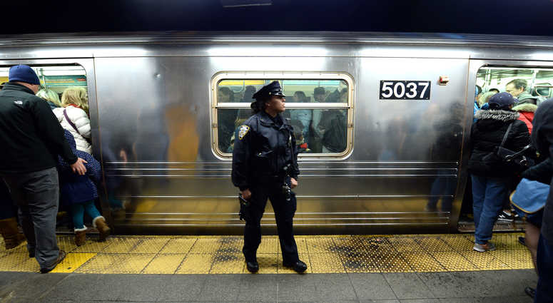 An NYPD officer in the subway. NYPD subway