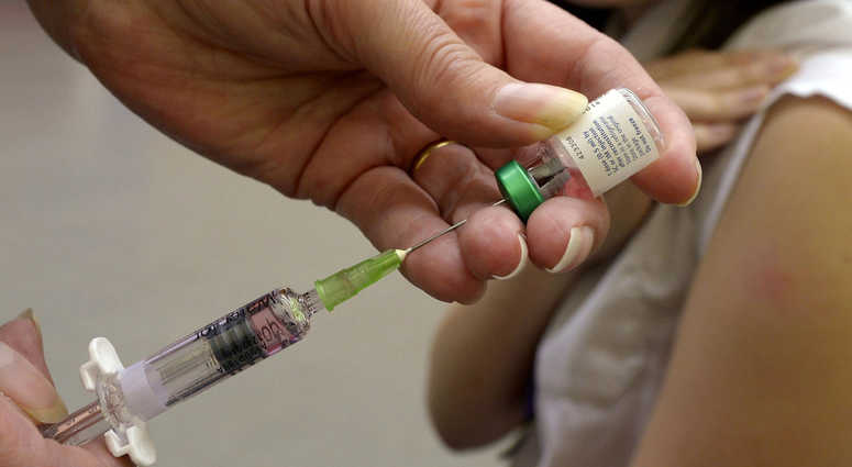 A measles vaccination being administered Measles
