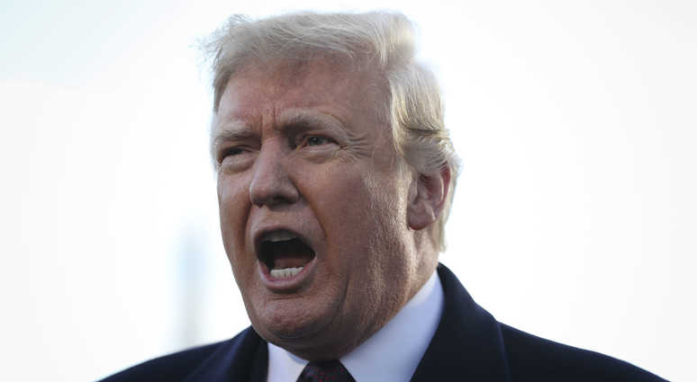 Caption: President Donald Trump talks to members of the media on the South Lawn of the White House before boarding Marine One on November 20, 2018 in Washington, DC. Trump