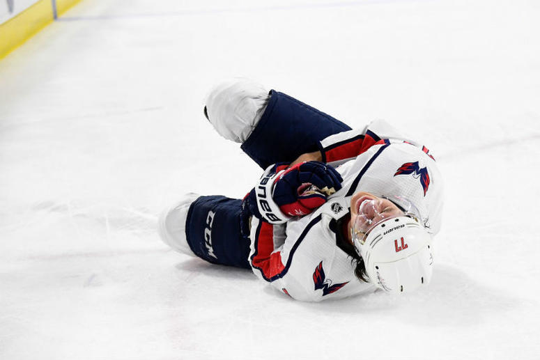 T.J. Oshie writhes in pain after getting shoved into the boards by Hurricanes winger Warren Foegele in the third period of Game 4 Caps-Hurricanes: T.J. Oshie leaves Game 4 with injury
