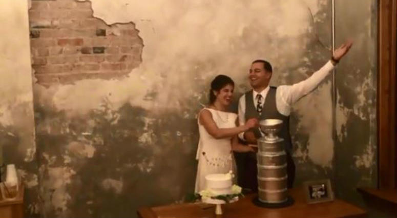 Lauren and Jeffrey cut into their Stanley Cup wedding cake Capitals_Stanley_Cup_Wedding_Cake