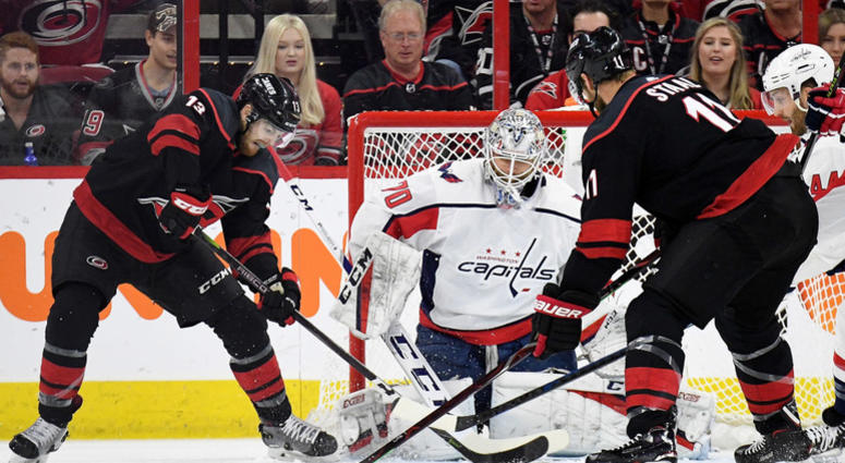 A pair of Hurricanes battle for position in front of Braden Holby's net. Capitals_Hurricanes