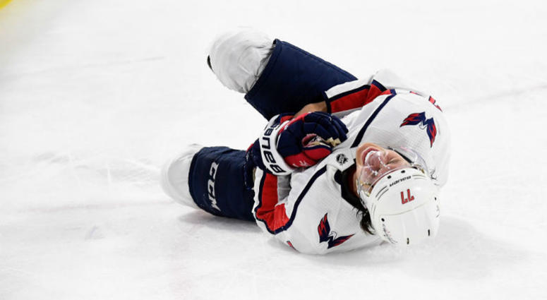 T.J. Oshie writhes in pain after getting shoved into the boards by Hurricanes winger Warren Foegele in the third period of Game 4 Caps-Hurricanes: T.J. Oshie leaves Game 4 with injury