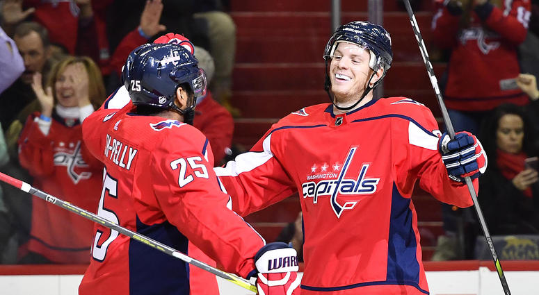 John Carlson gets congratulated by teammate Devante Smith-Pelly after scoring a goal Caps surprise youth hockey team that defended teammate against racism